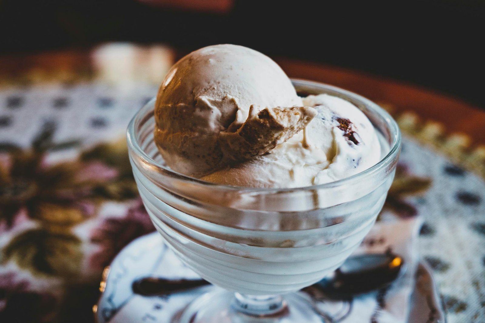 Delicious vanilla ice cream in a glass bowl, perfect for dessert indulgence.
